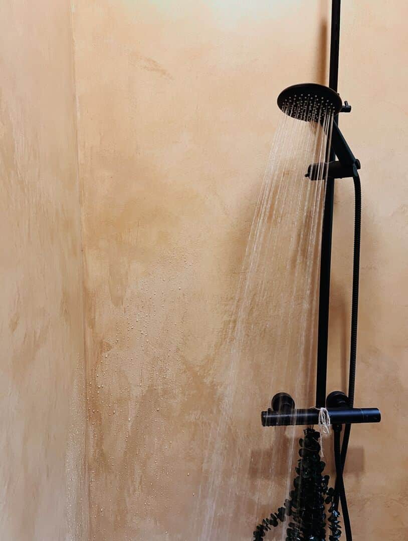 Tadelakt shower with warm plaster walls and rainfall showerhead